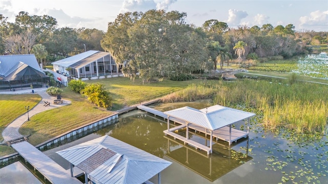 dock area with a water view and a yard