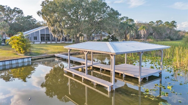 dock area featuring a water view and a yard