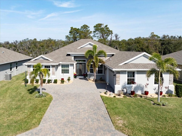 ranch-style house with a garage, central AC, and a front lawn