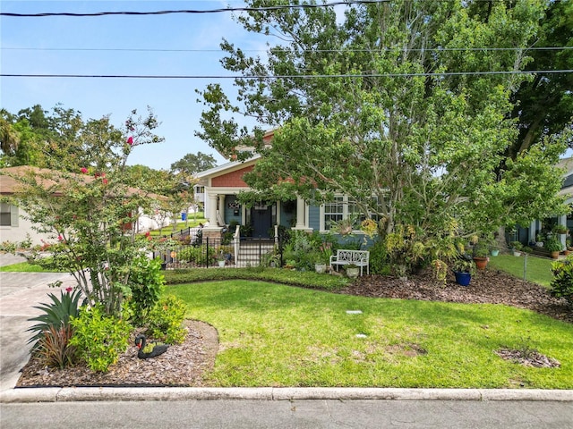 obstructed view of property with a front lawn