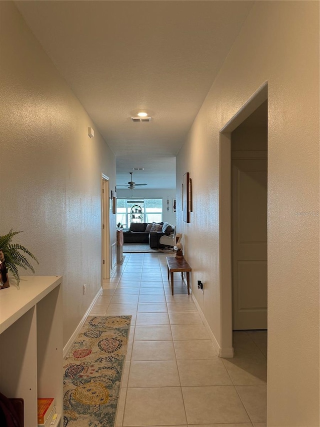 corridor featuring light tile patterned floors