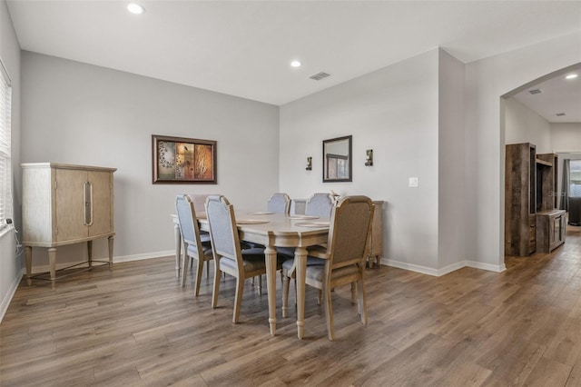 dining space with hardwood / wood-style floors