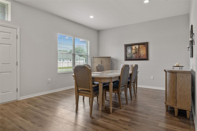 dining space with dark hardwood / wood-style flooring