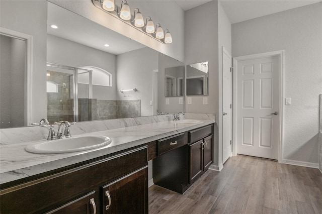 bathroom featuring vanity, a shower with door, and hardwood / wood-style floors