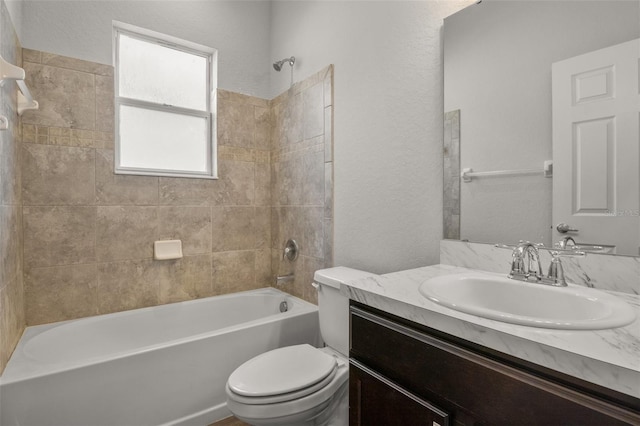 full bathroom featuring vanity, toilet, and tiled shower / bath