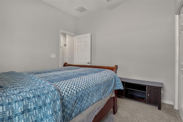 bedroom featuring light carpet