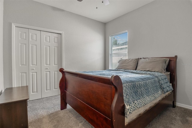 carpeted bedroom with ceiling fan and a closet