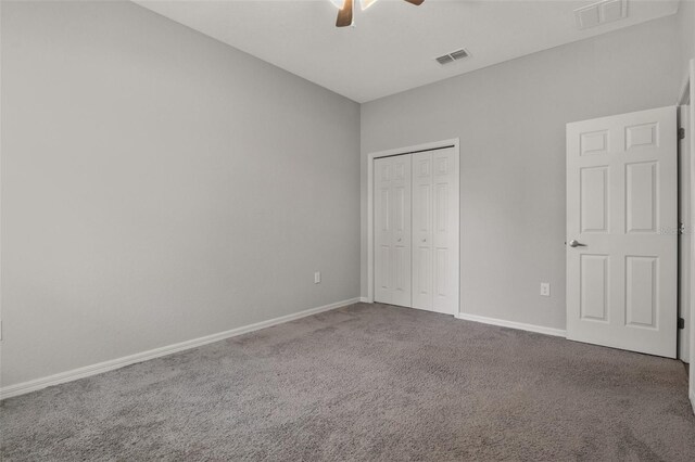 unfurnished bedroom featuring carpet flooring, ceiling fan, and a closet