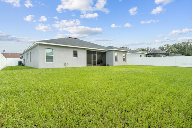 rear view of property with a lawn