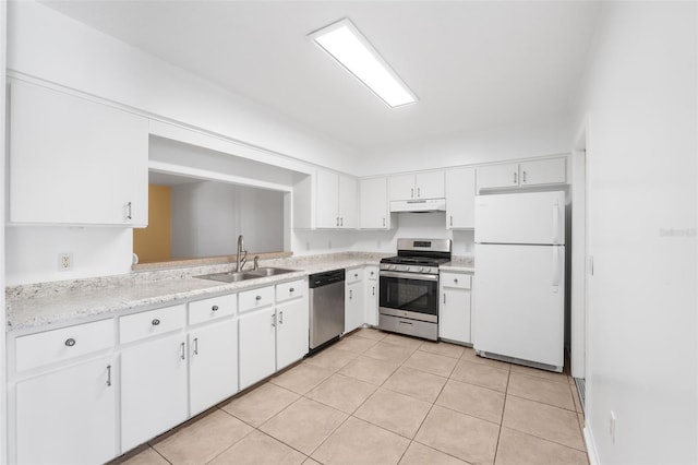 kitchen with sink, light tile patterned floors, white cabinets, and appliances with stainless steel finishes