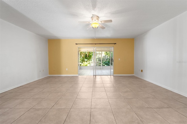 tiled empty room featuring a textured ceiling and ceiling fan