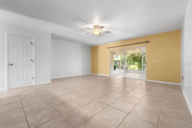 empty room with light tile patterned floors, a textured ceiling, and ceiling fan