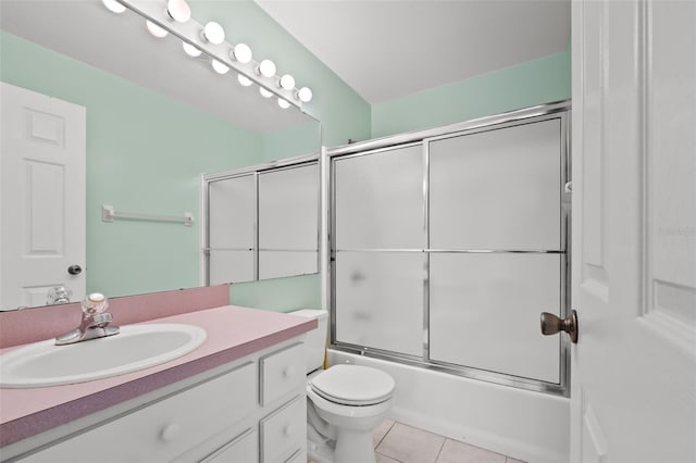 full bathroom featuring vanity, tile patterned floors, toilet, and combined bath / shower with glass door