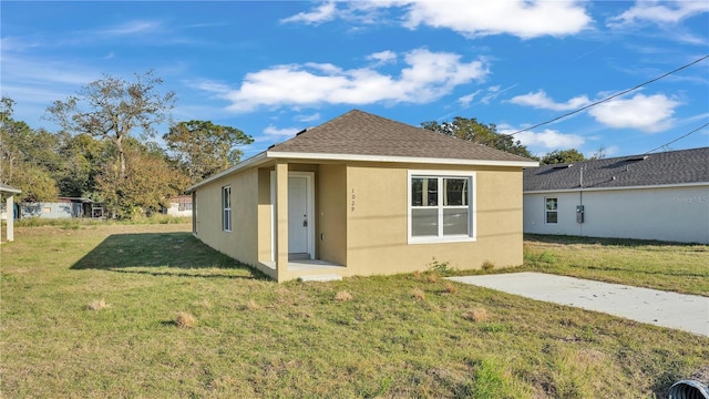 back of house with a lawn