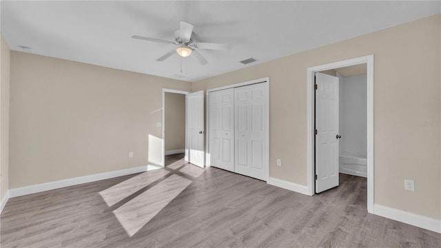 unfurnished bedroom featuring connected bathroom, a closet, ceiling fan, and light wood-type flooring