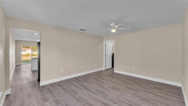 unfurnished room with ceiling fan and light wood-type flooring