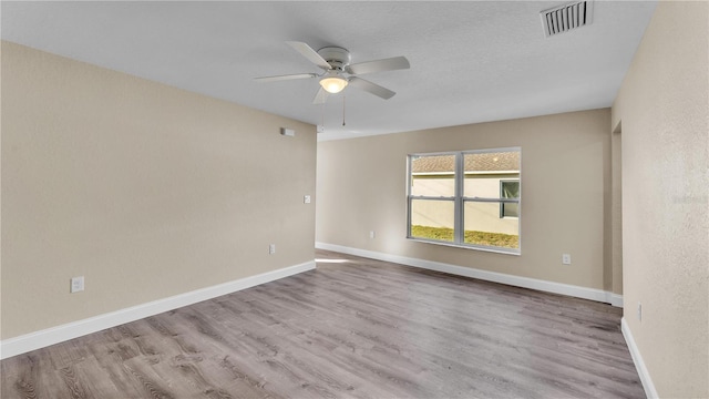 unfurnished room featuring ceiling fan and light hardwood / wood-style flooring