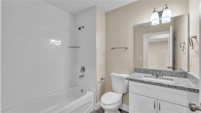 full bathroom with tiled shower / bath, vanity, and toilet