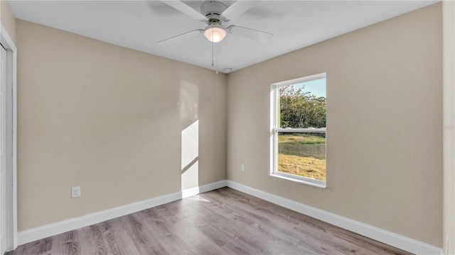 empty room featuring ceiling fan, light hardwood / wood-style floors, and a healthy amount of sunlight