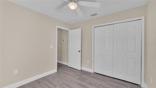 unfurnished bedroom featuring a closet, ceiling fan, and light hardwood / wood-style flooring