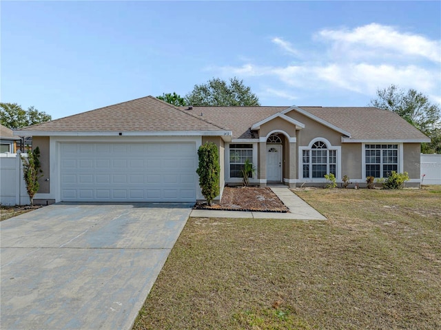 ranch-style home featuring a garage and a front yard