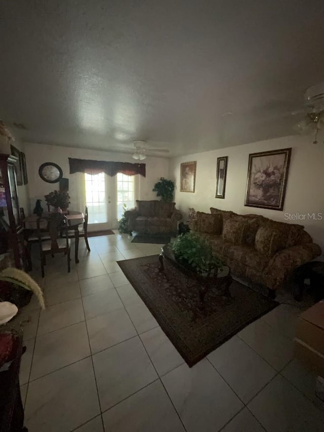 living room with ceiling fan and light tile patterned flooring