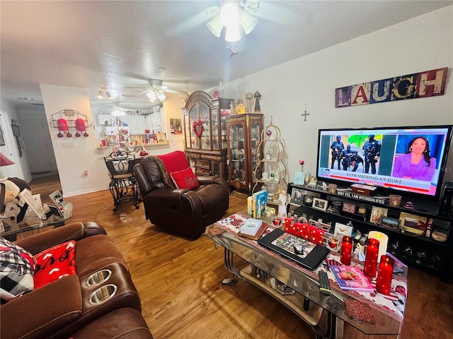 living room with hardwood / wood-style flooring and ceiling fan