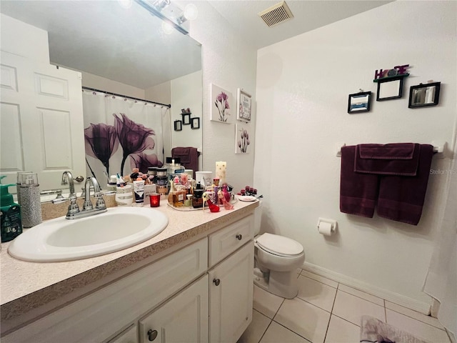 bathroom with tile patterned floors, toilet, and vanity