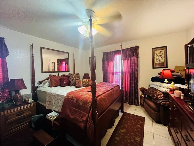 tiled bedroom featuring a textured ceiling and ceiling fan