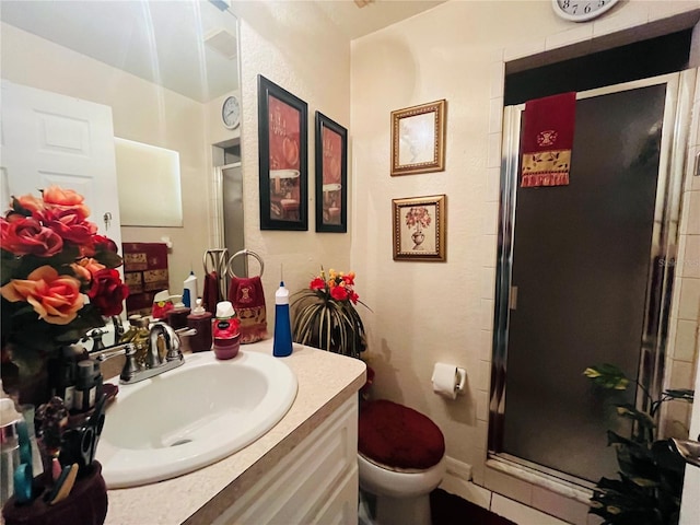 bathroom featuring vanity, toilet, and walk in shower