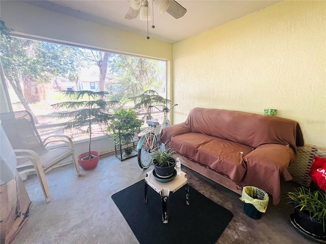 sunroom / solarium featuring ceiling fan