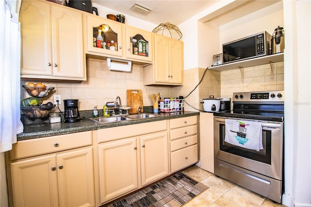 424 S Elm Rd, Lakeland, FL 33801 - kitchen featuring sink, backsplash, light tile patterned floors, stainless steel appliances, and light brown cabinets