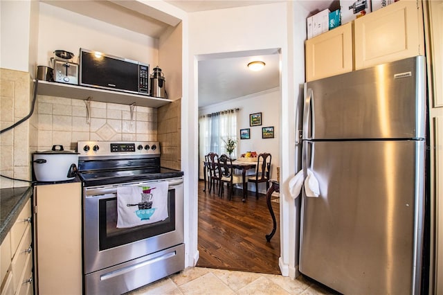 424 S Elm Rd, Lakeland, FL 33801 - kitchen featuring light tile patterned flooring, ornamental molding, appliances with stainless steel finishes, and decorative backsplash