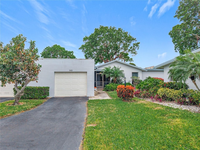 view of front of house with a garage and a front yard