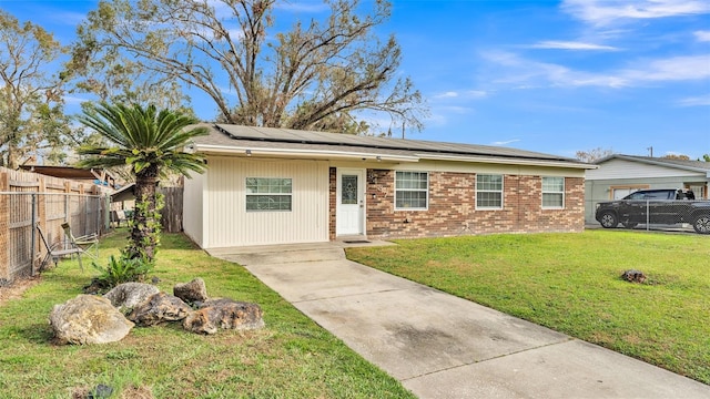 single story home with a front lawn and solar panels