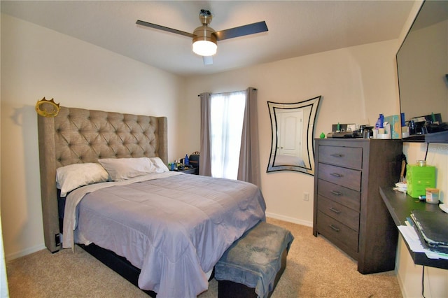 bedroom featuring light colored carpet and ceiling fan