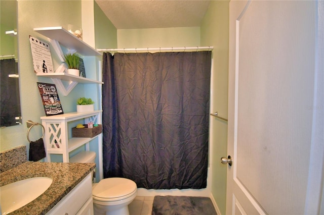 bathroom with vanity, a textured ceiling, and toilet