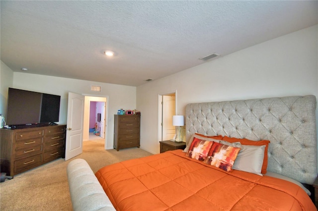 carpeted bedroom with a textured ceiling