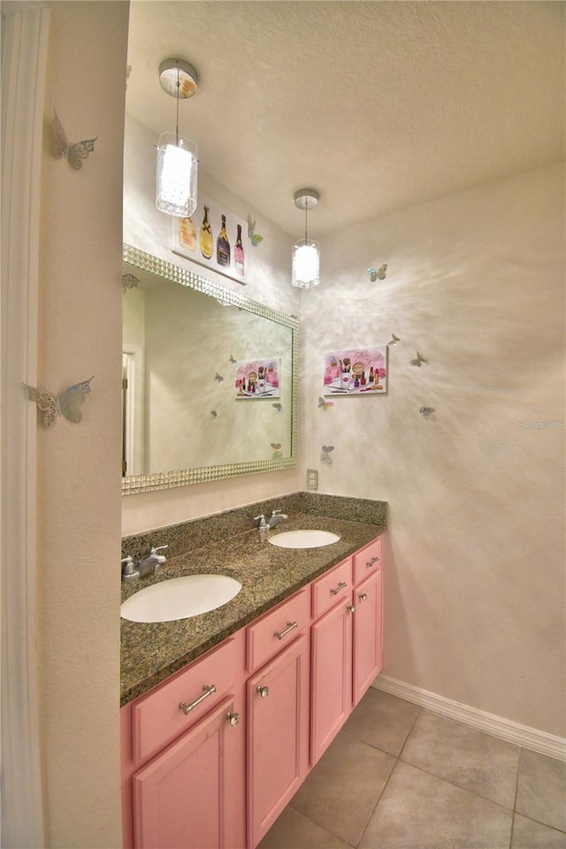 bathroom featuring tile patterned flooring, vanity, and a textured ceiling