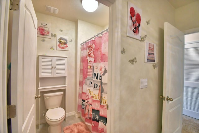 bathroom featuring toilet and a shower with shower curtain