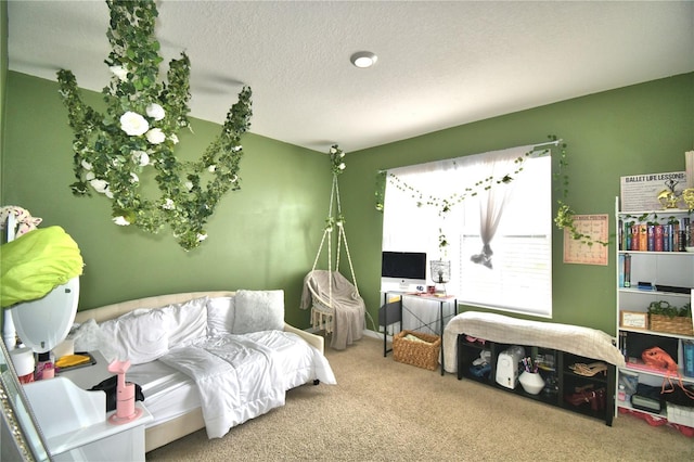 bedroom featuring carpet flooring and a textured ceiling