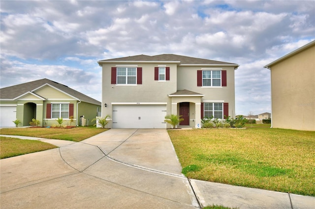 view of front of house featuring a garage and a front lawn