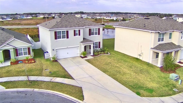 view of front of house with a garage and a front lawn