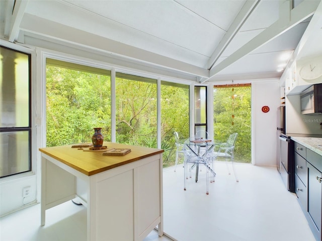 sunroom / solarium featuring lofted ceiling