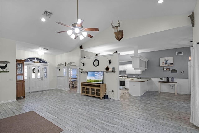 living room featuring high vaulted ceiling, sink, and ceiling fan