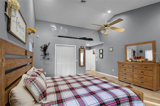 bedroom featuring high vaulted ceiling, ceiling fan, and light wood-type flooring