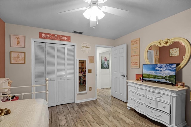 bedroom featuring ceiling fan, light wood-type flooring, and a closet