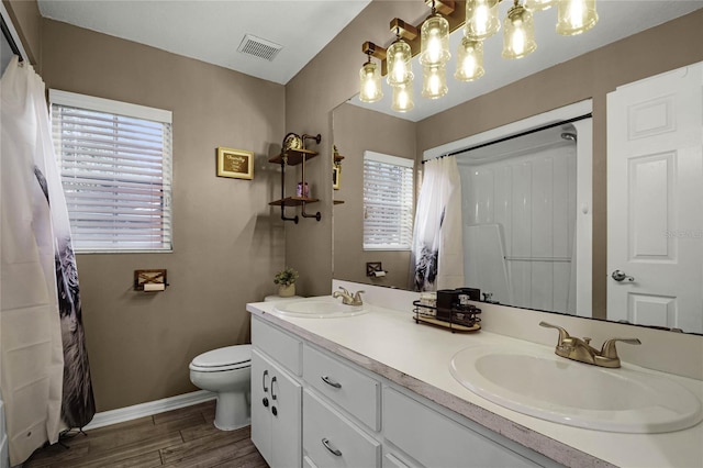 bathroom featuring vanity, hardwood / wood-style flooring, and toilet