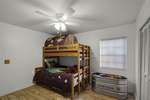 bedroom featuring a closet, ceiling fan, and light wood-type flooring