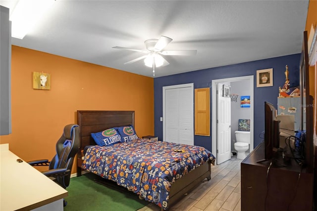 bedroom with ensuite bathroom, ceiling fan, light hardwood / wood-style floors, and a closet